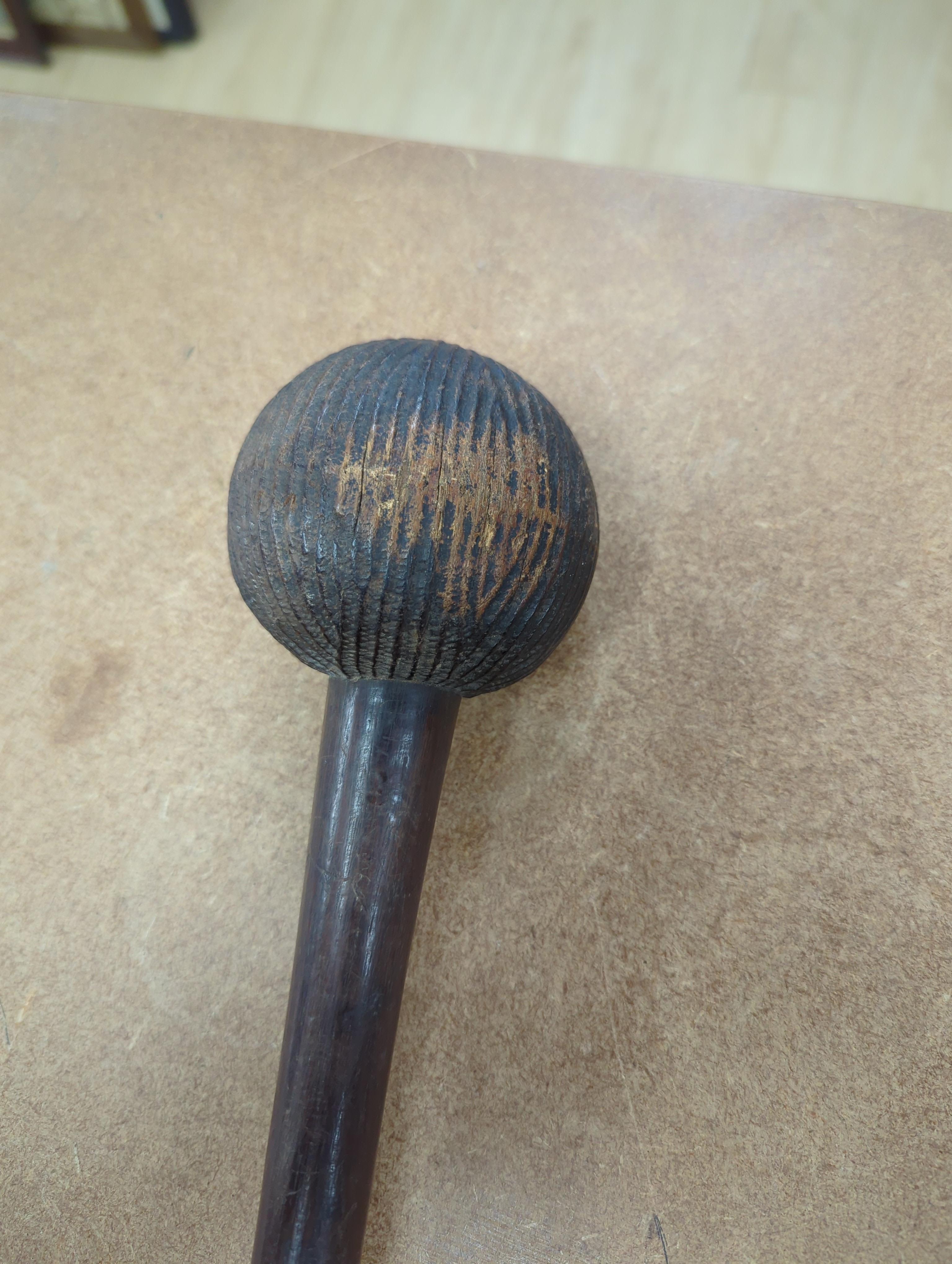 A tribal mask, a Knobkerrie and stick with carved head, stick 62.5cm